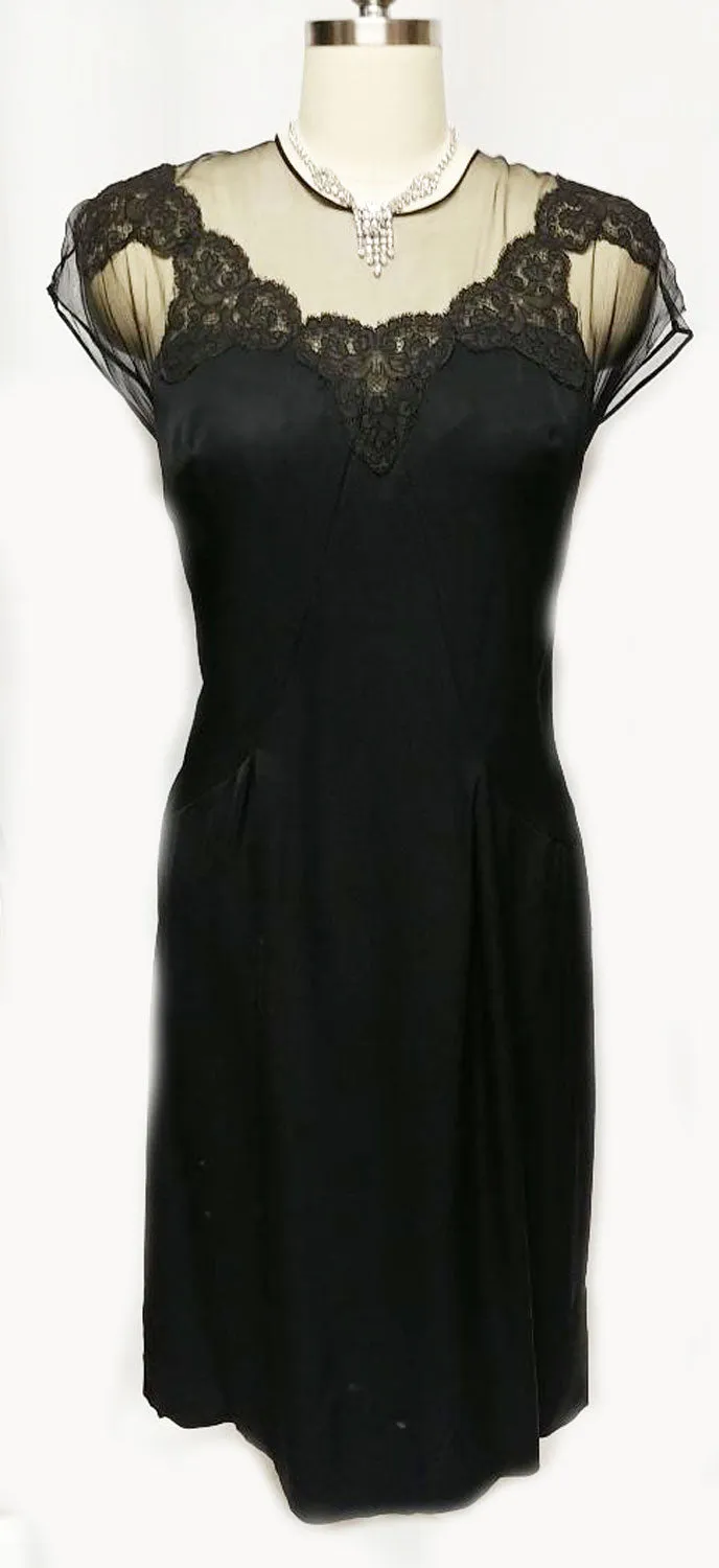 *VINTAGE "70S BLACK ILLUSION JEAN OF CALIFORNIA COCKTAIL DRESS ADORNED WITH CHANTILLY LACE